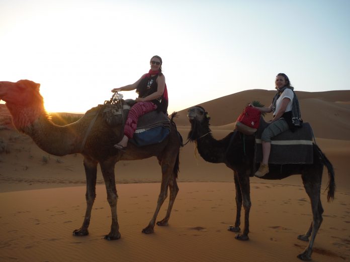 Sunrise camel ride in the Sahara Desert, Morocco.