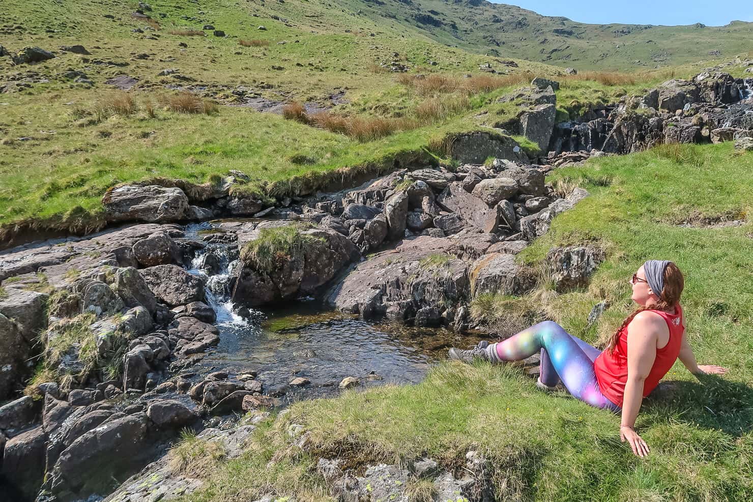 Helen in Wonderlust by a natural stream in the Lake District.