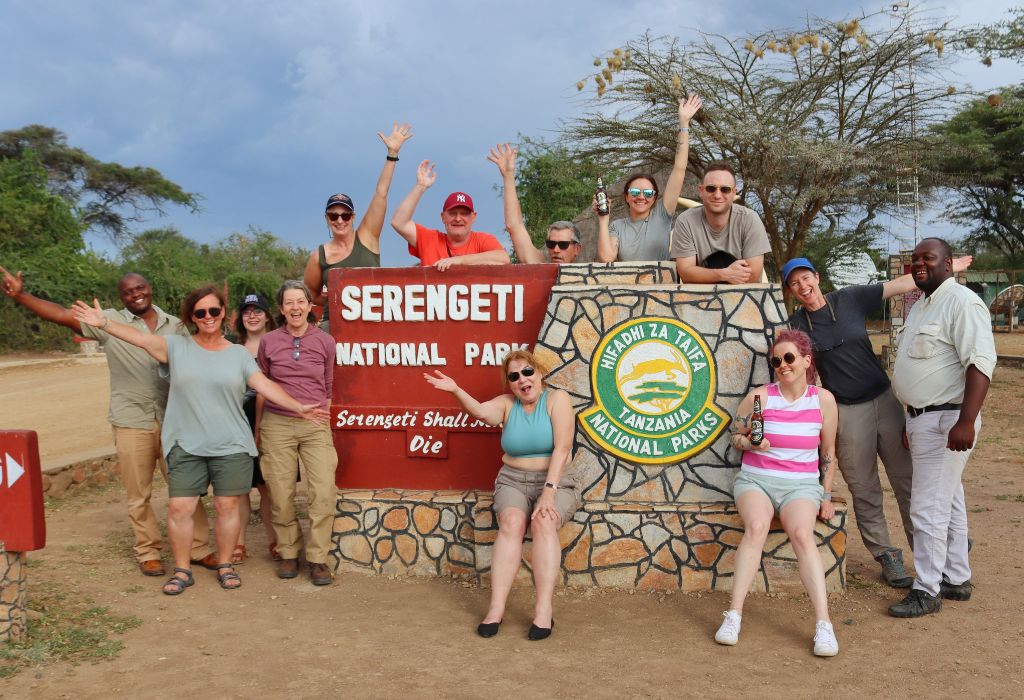 People at the Serengeti National Park sign